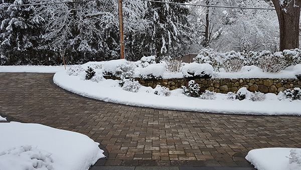 A radiant heated driveway with heated pavers